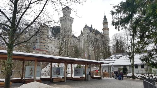 a group of people standing in front of a building at City House Alpeneck in Füssen