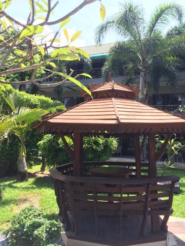 a wooden gazebo with a roof on a bench at Momento Resort in Pattaya South
