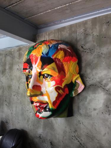a colorful mask hanging on a wall at Momento Resort in Pattaya South