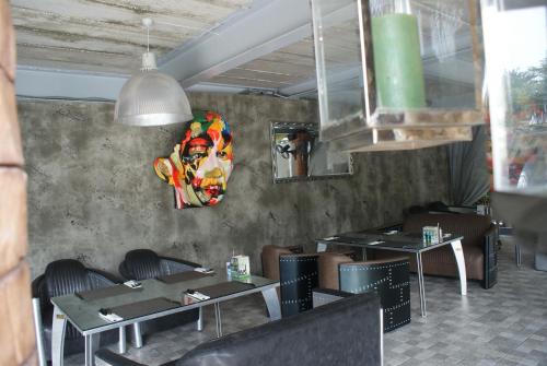 a dining room with tables and a mask on the wall at Momento Resort in Pattaya South