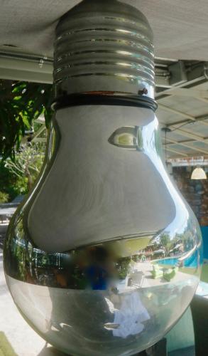 a glass jar with a reflection of a ship in it at Momento Resort in Pattaya South