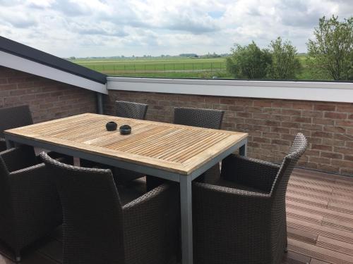 a wooden table and chairs on a patio at Charmehotel Kruishof in Ostend