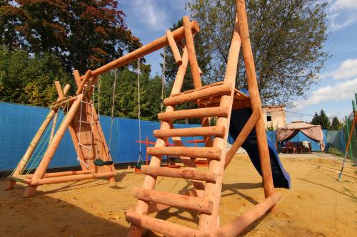 a wooden ladder sitting next to a playground at Hotel Restaurant Svejk in Bublava