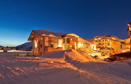 a group of buildings in the snow at night at Hotel Zehnerkar & Hotel Obertauern in Obertauern