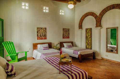 A bed or beds in a room at Casa D´Remedios La Bella Hotel Boutique