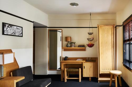 a living room with a table and a desk at Freehand New York in New York