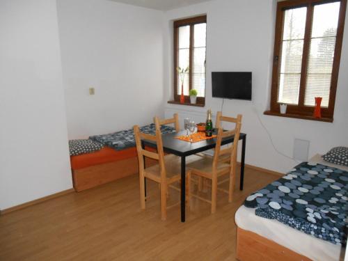 a dining room with a table and chairs in a room at Penzion V Zatáčce in Plzeň