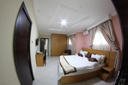 a bedroom with a bed with a dog laying on it at Celia's Suites in Abeokuta