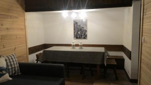 a dining room with a table and a couch at Les Esserts in Les Houches