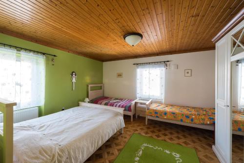 una camera con 2 letti e un soffitto in legno di Apartma Angelca a Kranjska Gora