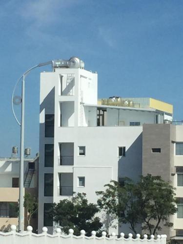 a white building with a street light in front of it at Tiin Tinn - Rivershore B&B in Taitung City