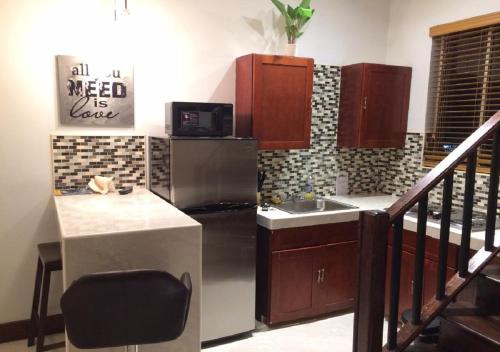 a kitchen with a stainless steel refrigerator and a sink at The Oasis Retreat in Nassau