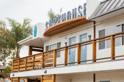 a building with a balcony with a sign on top at Surfhouse in Encinitas