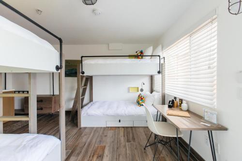 a bedroom with a desk and a bunk bed at Surfhouse in Encinitas