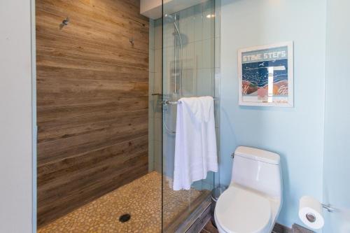 a bathroom with a glass shower with a toilet at Surfhouse in Encinitas