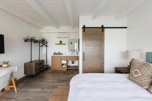 a bedroom with a bed and a wooden door at Surfhouse in Encinitas