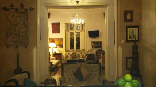 a living room with a couch and a chandelier at Casa Falleri Boutique Hotel in Lima