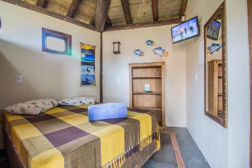 Uma cama ou camas num quarto em Cabanas do Rosa