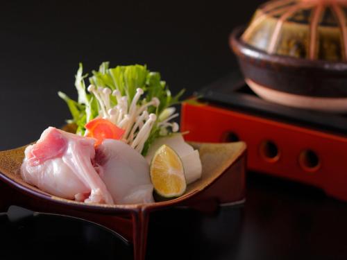 a bowl of food with meat and vegetables on a table at Saka Hotel Kyoto in Kyoto