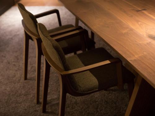 a wooden table with two chairs and a wooden table at Saka Hotel Kyoto in Kyoto