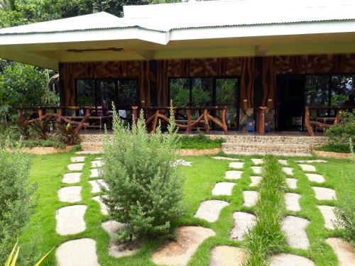 a garden with a pavilion with a stone walkway at Dabdab Tourist Inn in Sabang