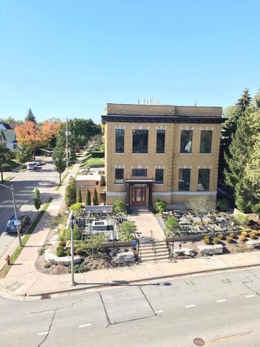 an old building with a garden in front of it at Kinn Guesthouse Bay View in Milwaukee