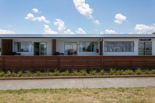 a house with a wooden fence at eMotel in Taupo