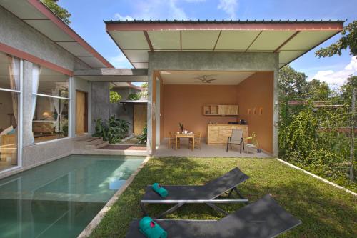 a backyard with a swimming pool and a house at Ambong Pool Villas - Private Pool in Pantai Cenang