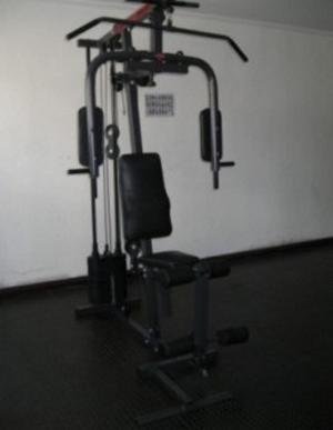 a exercise bike in a room with a chair at Hotel Areia Branca in Caraguatatuba