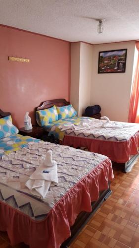 a room with two beds in a room at Nuevo Horizonte in Pasto