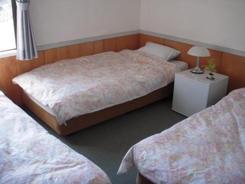 Postel nebo postele na pokoji v ubytování Guest House Ishitatu