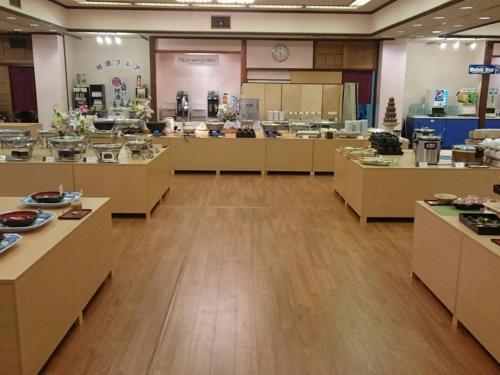 a large room with tables and counters in a cafeteria at Kindayu in Shibukawa