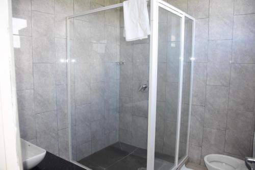 a shower with a glass door in a bathroom at Best View Apartments in Nadi
