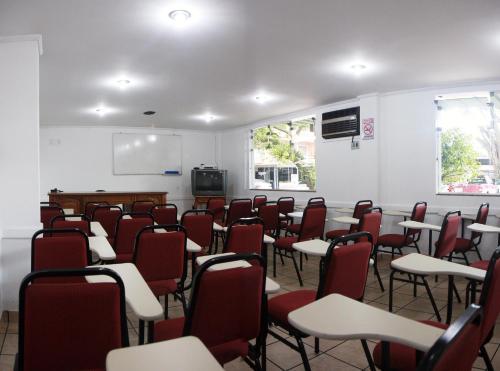 an empty classroom with chairs and a screen at Hotel Bruggemann in Florianópolis