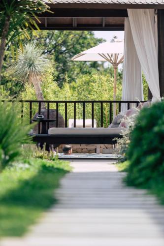 a patio with an umbrella and a table and chairs at Galboka Residence in Nerezine