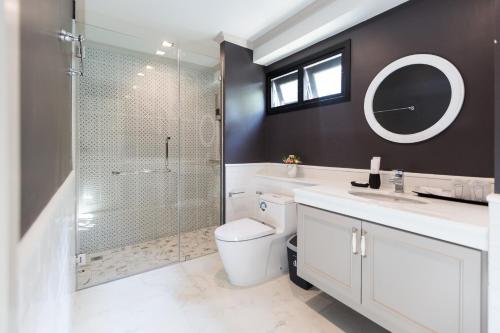 a bathroom with a shower and a toilet and a sink at Merchant House Chiangmai in Chiang Mai