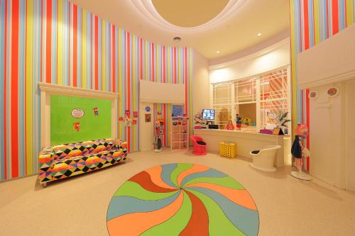 a childs room with a rainbow striped wall at Sueno Hotels Deluxe Belek in Belek