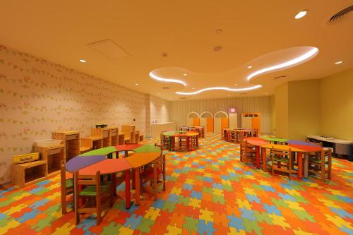 a classroom with desks and tables in a room at Sueno Hotels Deluxe Belek in Belek