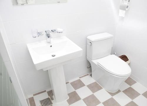 a white bathroom with a toilet and a sink at Saint Paul De Vence in Damyang