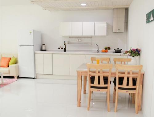 a kitchen with a table and chairs and a refrigerator at Saint Paul De Vence in Damyang