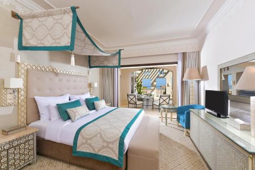 a bedroom with a king sized bed and a living room at Steigenberger Alcazar in Sharm El Sheikh