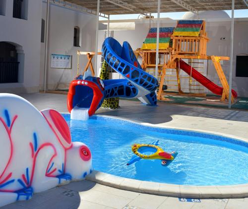a pool with a water slide and a playground at Steigenberger Alcazar in Sharm El Sheikh