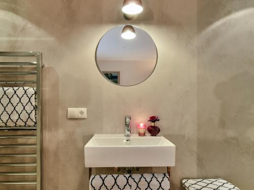 a bathroom with a white sink and a mirror at Chalet Kerber in Lech am Arlberg