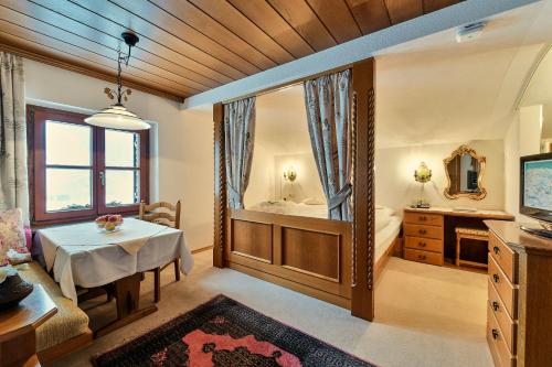 a living room with a table and a bathroom at Chalet Kerber in Lech am Arlberg