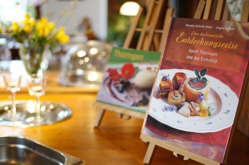 two signs on a table with food on it at Landhotel & Reiterhof Schumann in Triptis