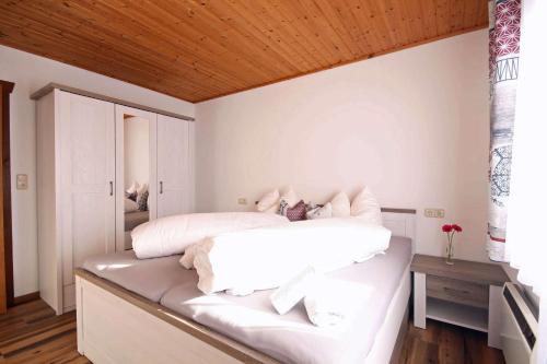 a bedroom with two beds with white sheets at Almliesl ZELL-448 in Zell am See