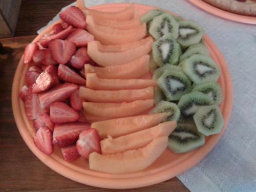 a plate of fruits and vegetables on a table at La Maison Galu' in Itri