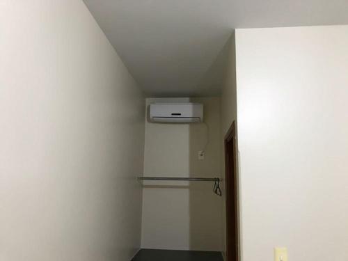 a room with a white wall with a air conditioner at Lider Hotel in Jataí