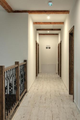 an empty hallway with wooden railings and white walls at Penzión Pri Mlyne in Nitra