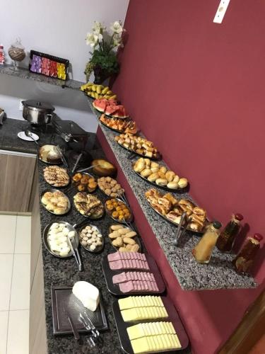 a buffet line with many different types of food at Lider Hotel in Jataí